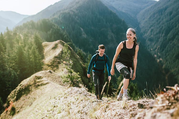 Are Varicose Veins a Sign of Poor Health? 1 couple hiking on a mountain scaled min
