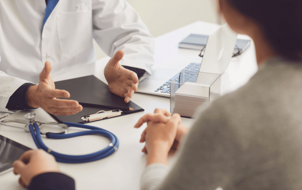 A doctor talking to a patient at a vein clinic
