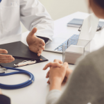 A doctor talking to a patient at a vein clinic